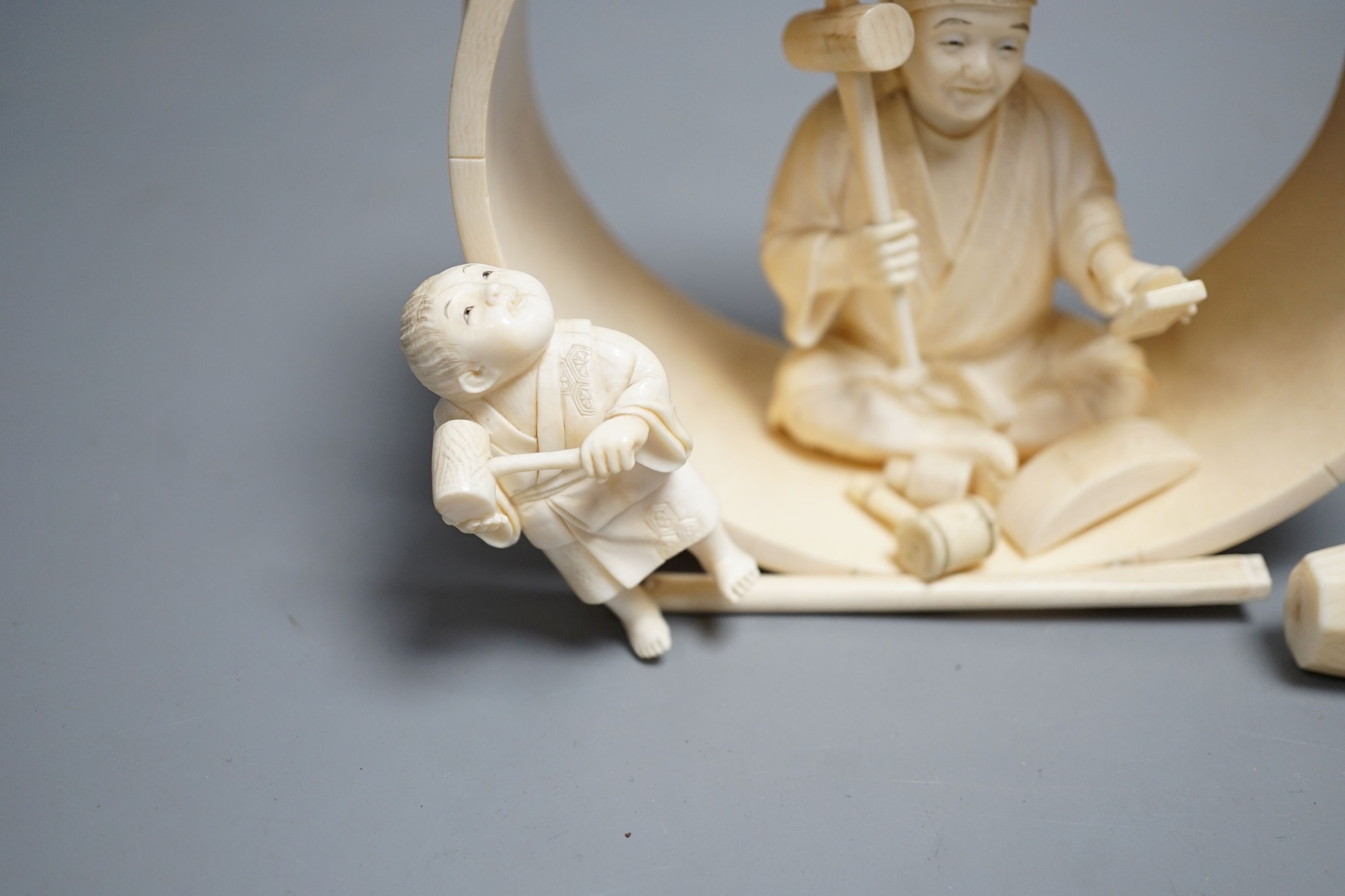 A Japanese ivory okimono of carpenter and child, Meiji period 15cm